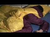 ENNI wearing a sexy purple shiny nylon rain suit lying in bed with yellow shiny nylon cloths lolling and posing (Video)