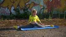 Anastasia is doing some fitness and stretching while smoking outdoors