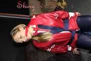 Sexy Sandra wearing sexy red/blue rainwear being tied and gagged with ropes and a clothgag on a chair (Pics)