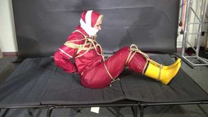 Alice bound and gagged in a nylon Rainsuit
