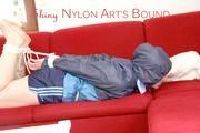 Jill tied, gagged and hooded with ropes on as sofa wearing a blue shiny nylon shorts and a blue oldschool rain jacket (Pics) 