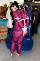 Jill tied and gagged in a semi-transparent purple PVC suit