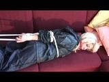 03:06 Min. video with Nina tied in a blue nylon rainsuit