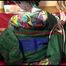 Lucy tied and gagged on a bed with red shiny nylon cloth wearing supersexy green rainwear (Video)