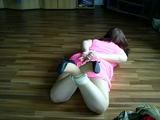 Sandra hogtied on the floor