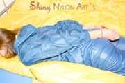 Alina wearing a sexy shiny rainwear suit in blue lolling on bed cuffed (Pics)