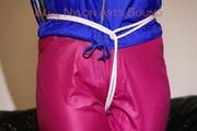 Mara tied, gagged and hooded on a black covered sofa wearing a super hot pink rain pants and a blue rain Jacket (Pics)