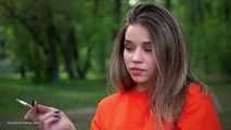Pretty Kate is smoking Marlboro Red 100s in the park