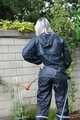 Watch Chloe enjoying her shiny nylon Rainwear doing some watering in the garden