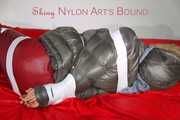 ***NEW MODEL*** Sandra wearing highheels and a sexy red crazy sensation skibib as well as a grey down jacket tied and gagged on a sofa with tape (Pics)