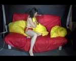 Sexy Mara wearing only a red shiny nylon shorts lolling and posing on the sofa (Video)