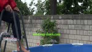 Watch Sandra enjoying the Pool during a hot summer Day with her shiny nylon Downjacket