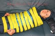 Katharina tied and gagged with tape on a sofa wearing shiny rainwear (Pics)