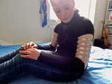 Lea wearing five very tight hose clamps on each arm