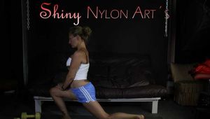 Watching sexy Sandra wearing a sexy lightblue shiny nylon shorts and a white top during her workout with barbells (Pics)