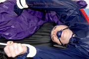 Jill tied and gagged in shiny nylon rainware