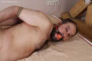Amanda ties up and gags a man, then spanks and tickles him