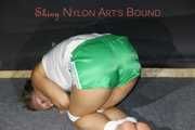 Watching sexy Sandra wearing a sexy green shorts and a white top being tied and gagged on the floor with ropes and a cloth gag (Pics)
