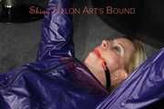 Watching sexy Pia wearing a sexy blue oldschool shiny nylon shorts and a rain jacket being tied and gagged on hands and feet on the ceiling lying on the floor (Pics)