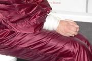 Isabelle tied and gagged in a shiny downwear