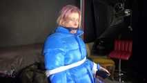 Sexy Pia being tied and gagged with ropes and a cloth gag on a hairdressers chair wearing a sexy blue shiny nylon rainpants and a lightblue downjacket (Video)